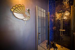 a bathroom with a shower with a fan on the wall at 2 pièces à Bastille in Paris