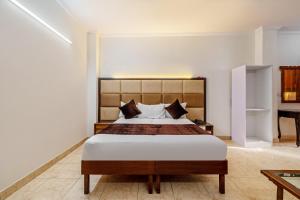 a bedroom with a large bed in a room at Hotel South Indian in New Delhi