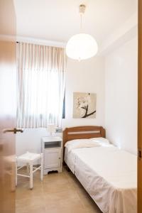 a bedroom with two beds and a table and a window at Llevant 3 in L'Ampolla