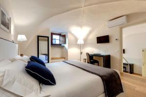 a bedroom with a large white bed with blue pillows at B&B Dell'Olio in Florence +51 photos