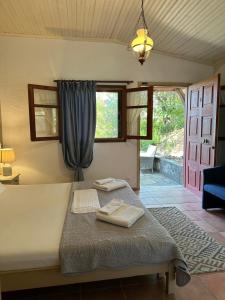 a bedroom with a bed with two towels on it at Villa Rena in Vourvourou