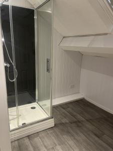 uma cabina de duche com cabina de duche em vidro num quarto em OYO Queens Quarter em Belfast
