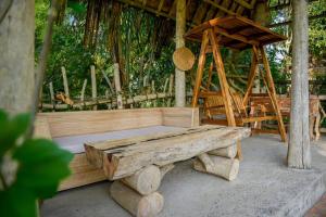 a wooden bench sitting in front of a tent at Abing Dalem - Villa Manggis in Tabanan