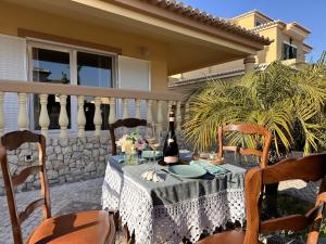 a table with two bottles of wine on a balcony at Holiday House Praia D Ana in Lagos