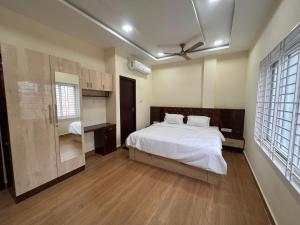a bedroom with a bed and a ceiling fan at Shri Kailasha Residency in Tiruvannāmalai