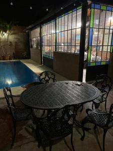 a table and chairs next to a swimming pool at Quincho por dia in Corrientes