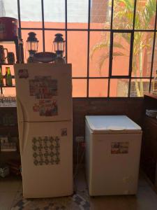 two refrigerators sitting next to each other in a room at Quincho por dia in Corrientes