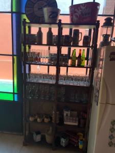a shelf with bottles and glasses in a refrigerator at Quincho por dia in Corrientes