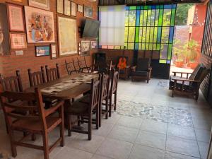 a dining room with a long table and chairs at Quincho por dia in Corrientes
