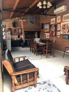 a living room with a couch and a table and chairs at Quincho por dia in Corrientes
