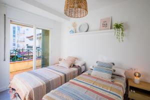 two beds sitting next to each other in a bedroom at La Calma in Platja  d'Aro +25 photos