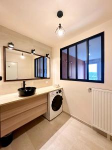 een badkamer met een wastafel en een wasmachine bij Appartement chaleureux - Meaux in Meaux