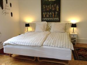a large white bed in a bedroom with two lamps at Copenhagen Open Plan House in Hellerup in Hellerup