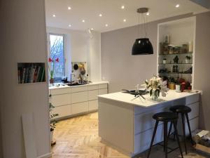 a kitchen with a counter and two bar stools at Copenhagen Open Plan House in Hellerup in Hellerup