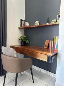 a wooden desk with a chair and books at Burj Calapan in Calapan