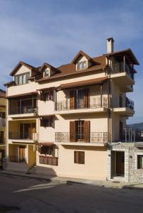 un edificio de apartamentos con balcones en una calle en Kalavrita Krinides Apartments and Attics, en Kalavrita