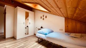 a bedroom with a bed with a wooden ceiling at Haus Hochhäusler in Schneizlreuth