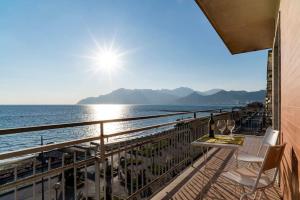 a balcony with a table and chairs and the ocean at Salerno e Costiera Amalfitana al Top in Salerno