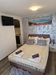 a bedroom with a bed with two towels on it at Apartments Vukman in Trogir
