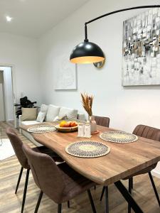 a dining room table with chairs and a black lamp at Designer City Apartment in Top Lage für 6 Gäste in Karlsruhe