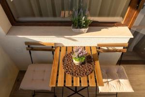 a table with a bench with flowers on it at View in Petrich
