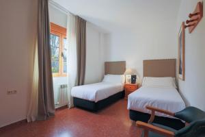Postel nebo postele na pokoji v ubytování Hotel Tugasa El Almendral