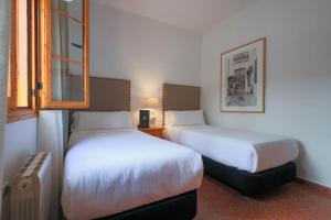 Postel nebo postele na pokoji v ubytování Hotel Tugasa El Almendral