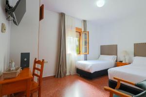 Postel nebo postele na pokoji v ubytování Hotel Tugasa El Almendral