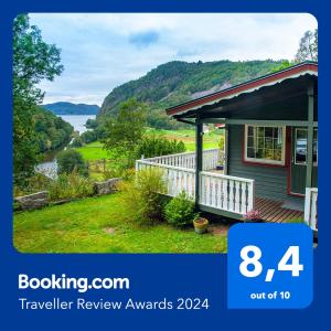 a small house with a view of a lake at Lyngebu. Nice family cabin with sea view. in Lyngdal