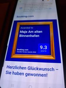 a cell phone screen with a picture of a sign on it at Maje Am alten Binnenhafen in Emden
