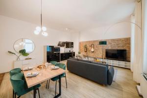 a living room with a table and a couch at NEW Luxurious Loft in central Berlin BY HOMELY in Berlin