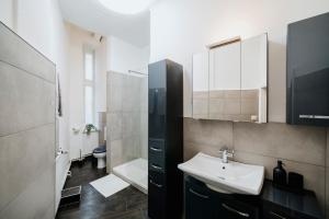 a bathroom with a sink and a toilet and a mirror at NEW Luxurious Loft in central Berlin BY HOMELY in Berlin