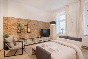 a bedroom with a large bed and a brick wall at NEW Luxurious Loft in central Berlin BY HOMELY in Berlin
