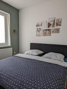 a bedroom with a bed with a blue comforter at Ferienwohnung am Theater 2 in Schweinfurt