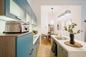 a kitchen with a sink and a counter with a toaster at NEW Urban Oasis - Sleek Apartment BY HOMLEY in Berlin