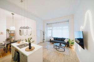 a living room with a couch and a table at NEW Urban Oasis - Sleek Apartment BY HOMLEY in Berlin