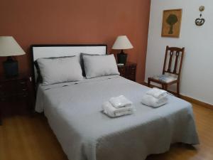 a bedroom with a bed with two towels on it at Departamento turista in Mendoza