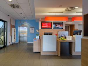 a lobby of a hospital with a reception desk at ibis Heilbronn City in Heilbronn