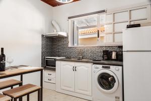 een keuken met wasmachine en droger bij Dada's Cottage in Argyrádes +30 foto's