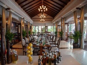 a long dining room with a long table and chairs at Sofitel Krabi Phokeethra Golf and Spa Resort in Klong Muang Beach