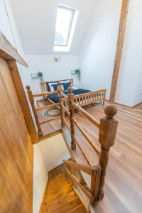 a wooden staircase in a house with a skylight at Fernweh Haus Brasov in Braşov