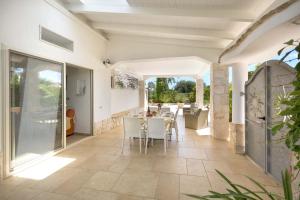 een patio met een tafel en stoelen erop bij Trullo Mimosa by Perle di Puglia in San Michele Salentino