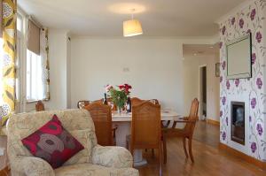 a living room with a couch and a table with chairs at Tawel Fryn Bungalow near Dolgellau in Dolgellau