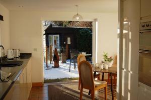 a kitchen with a table and chairs and an open door at Tawel Fryn Bungalow near Dolgellau in Dolgellau