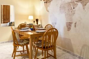a dining room table with chairs and a world mural on the wall at Well located Apt Buġibba St Paul's Bay - Happy Rentals in St. Paul's Bay