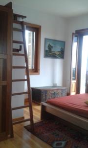a bedroom with a ladder next to a bed at Ktima Charitou in Kalamaki Messinia
