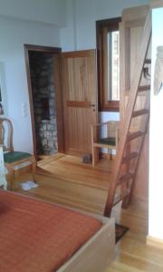 a living room with a staircase and a fireplace at Ktima Charitou in Kalamaki Messinia