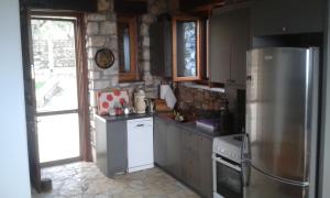 a kitchen with a refrigerator and a stove at Ktima Charitou in Kalamaki Messinia