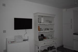 a living room with a television on a white wall at 7 Plants Yard in Worksop