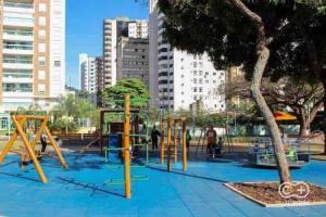 a playground with yellow equipment in a city at Sun Square Marista Vista Pça do Sol! Hospitais,mercados e cartórios, tudo perto! 301 in Goiânia